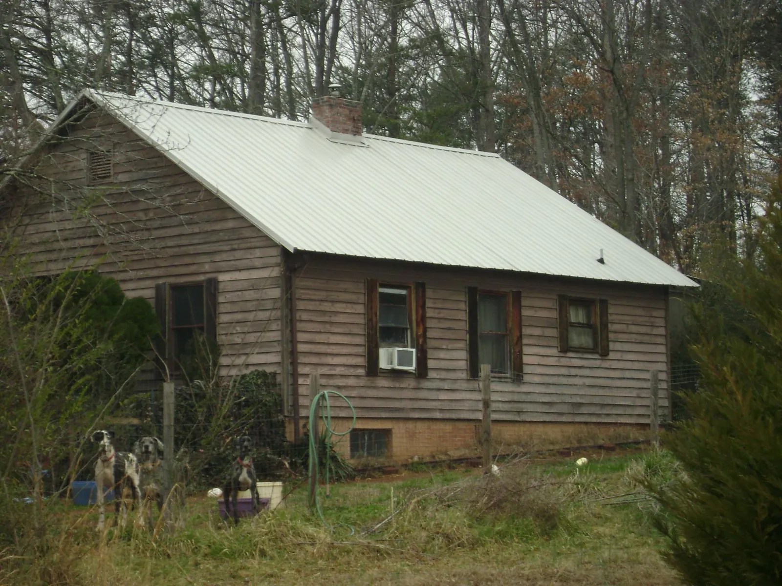White metal roof on an old wood sided farmhouse, from a Metal Roof Installation job in Steger